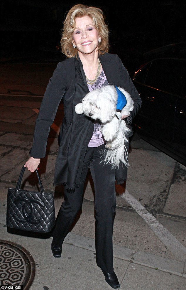 Here she comes: Jane Fonda is in high spirits as she arrives at Craig's in West Hollywood on Wednesday evening