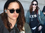 Makeup free Kristen Stewart covers up her bedhead with a beanie as she arrives in Paris
