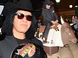 Ride 'em cowboy! KISS rocker Gene Simmons good naturedly agrees ride a mechanical bull at a rodeo event Saturday in Anaheim, California 