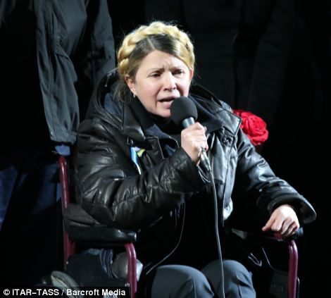 Former Ukrainian Prime Minister Yulia Tymoshenko speaks as she seats in a wheelchair at Independence Square
