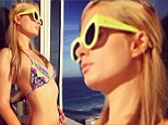 'Another day in Paradise': Paris Hilton poses in tiny string bikini on the balcony of her Miami hotel room