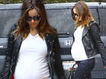 Wet and Wilde! Pregnant Olivia shows off her growing baby bump in a leather motorcycle jacket while out in the rain
