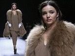 It's the catwalk not the llama strut: Miranda Kerr heads down the runway in Paris wearing over-the-top animal style gillet