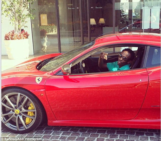 Living it up: Barkhad Abdi, 28, gets behind the wheel of a Ferrari in Hollywood