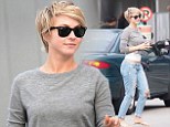 Julianne Hough shows a peek of her toned tummy in a cropped jumper and low-riding  distressed denim