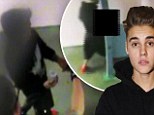 Justin Bieber seen urinating into a cup for his drug test in newly released police video from his time in Miami jail