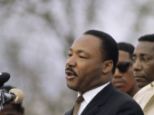 Historic: Dr. Martin Luther King at the podium giving a speech in Montgomery, Alabama - with his Bible visible on the rostrum