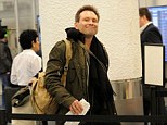 Actor Christian Slater making his way through Miami International Airport with a therapy dog
