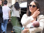 One content mum! Lauren Silverman cuddles baby Eric in her arms as she steps out in London with Simon Cowell