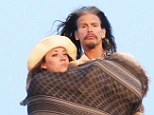Wrapped up: Steven Tyler watched the sunset in Malibu on Sunday, wrapped up in a shawl with a mystery girl