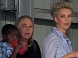 She gave Sean Penn a day off! Charlize Theron looks heavily made up as she exits a photo shoot with her mom and son in tow... as boyfriend is nowhere in sight