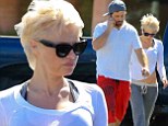 Hard to stomach! Pamela Anderson flashes her navel as she goes for a stroll with husband Rick Saloman