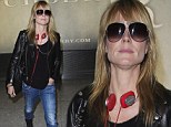 Flying business casual! Heidi Klum goes rocker chic in leather jacket, jeans and sneakers while arriving at Heathrow