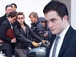 Rough ride! Robert Pattinson looks worried as he sits on motorcycle pillion behind co-star Dane DeHaan while filming Life