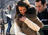 Now THAT'S multi-tasking! Keri Russell cuddles daughter Willa and teaches her to fly a kite whilst on set of The Americans