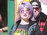 Purple haze: In keeping with her lilac hair and lipstick, Kelly opted for a pair of sunglasses in a similar colour