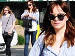 Borrowed from your boyfriend's closet? Dakota Johnson sports oversized pinstriped shirt for shopping trip with sister Stella