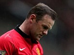 Head down: Rooney appears dejected after Liverpool took a one-goal lead
