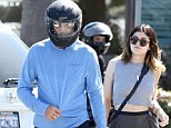 Suddenly camera shy? Reality TV star Bruce Jenner hides under motorcycle helmet as he bonds with daughter Kylie in Malibu