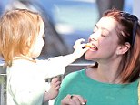 Open wide, mommy! Alyson Hannigan's daughter feeds her a treat as the family gets decked out in green for St Patrick's Day
