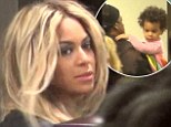 ¿I woke up like this¿: Beyoncé looks Flawless as she arrives at airport in full stage make-up with baby Blue and Jay Z