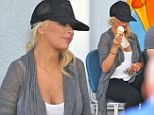 Christina Aguilera reveals hint of baby bump for first time in a tank top and tights after 'pregnancy news'