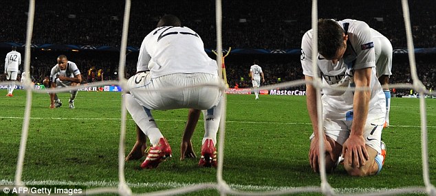 Down and out: James Milner (right), Fernandinho (centre) and Vincent Kompany are distraught at the end