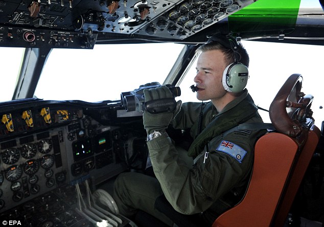 Scouring: Royal Australian Air Force pilot Russell Adams searches an area some 2,500 kilometres southwest of Perth for debris possibly from MH370