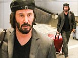 Keanu Reeves takes his mane undercover in a jaunty hat for airport run... after being spotted with a white patch on scalp