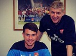 All smiles: Ramsey posted this picture of himself signing his new contract with Wenger on Instagram