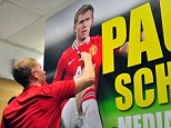 Sign of the times: Scholes autographs a poster during a promotional trip to Singapore