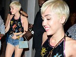 Can't Be Tamed: Miley Cyrus parties hard in denim hot pants after Miami concert... while a hardcore fan is carted off in an ambulance