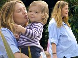Pregnant Drew Barrymore displays huge baby bump as she plants loving kiss on 17-month-old daughter Olive