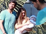 Doting Dad: New father Mark Philippoussis carries young son cradled in his arms en route to church ceremony