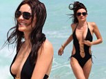 Model Kira Dikhtyar suffers wardrobe malfunction in VERY risque swimsuit... after claiming 'bully' Naomi Campbell left her psychologically damaged