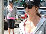 Pregnant newlywed Stacy Keibler hides her baby bump under baggy sweatshirt as she works out in West Hollywood