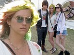 Kesha shows off wrapped ankle while rocking a floral print romper and multicoloured hair at Coachella