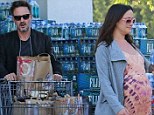 Doting dad: David Arquette hauls the groceries while pregnant girlfriend, Christina McLarty, leads the way
