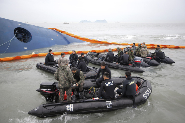 South Korean rescue team members prepare to search for passengers of a ferry sinking off South Korea's southern coast