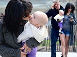 Legs eleven! Hilaria Baldwin flashes her enviably toned pins in tiny denim cut-offs as she dotes on adorable daughter Carmen during family outing