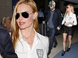 Kate Bosworth went for a sexy yet quirky look as she arrived in LA, teaming her shorts with a preppy white shirt bearing a crest motif