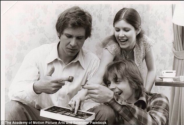Life is sweet: Harrison Ford, Carrie Fisher and Mark Hamill can be seen eating a box of chocolates in rare photos from the set of Star Wars, which belong to Carrie