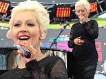 Pregnant Christina Aguilera proudly shows off baby bump in tight black dress as she takes stage at Wango Tango