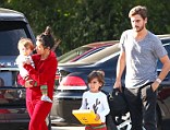 Let's hope shes not a bridesmaid! Kourtney Kardashian sports red onesie and messy hair for family dinner... six days before Kim's wedding