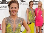 Taking the plunge together! Carrie Underwood and Miranda Lambert show off their cleavage in colourful dresses at the Billboard Music Awards