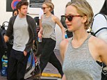 That's a bit more District 12! Jennifer Lawrence and Liam Hemsworth swap red carpet glamour for causal grey attire in Cannes