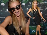 Decalescent DJ: Paris Hilton flashed the flesh in a cut-out black bandage dress at DJ at VIP Room in Cannes, France Friday night