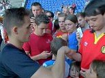 Fan fare: The United youngster signs autographs for Belgium supporters