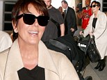 Doting grandma: Kris Jenner pushed baby North in a stroller as she flew into LAX on Monday