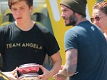Healthy habits: Handsome footballer David Beckham and his 15-year-old son Brooklyn stopped by Juice Crafters in Brentwood on Tuesday to pick up some healthy treats for the family